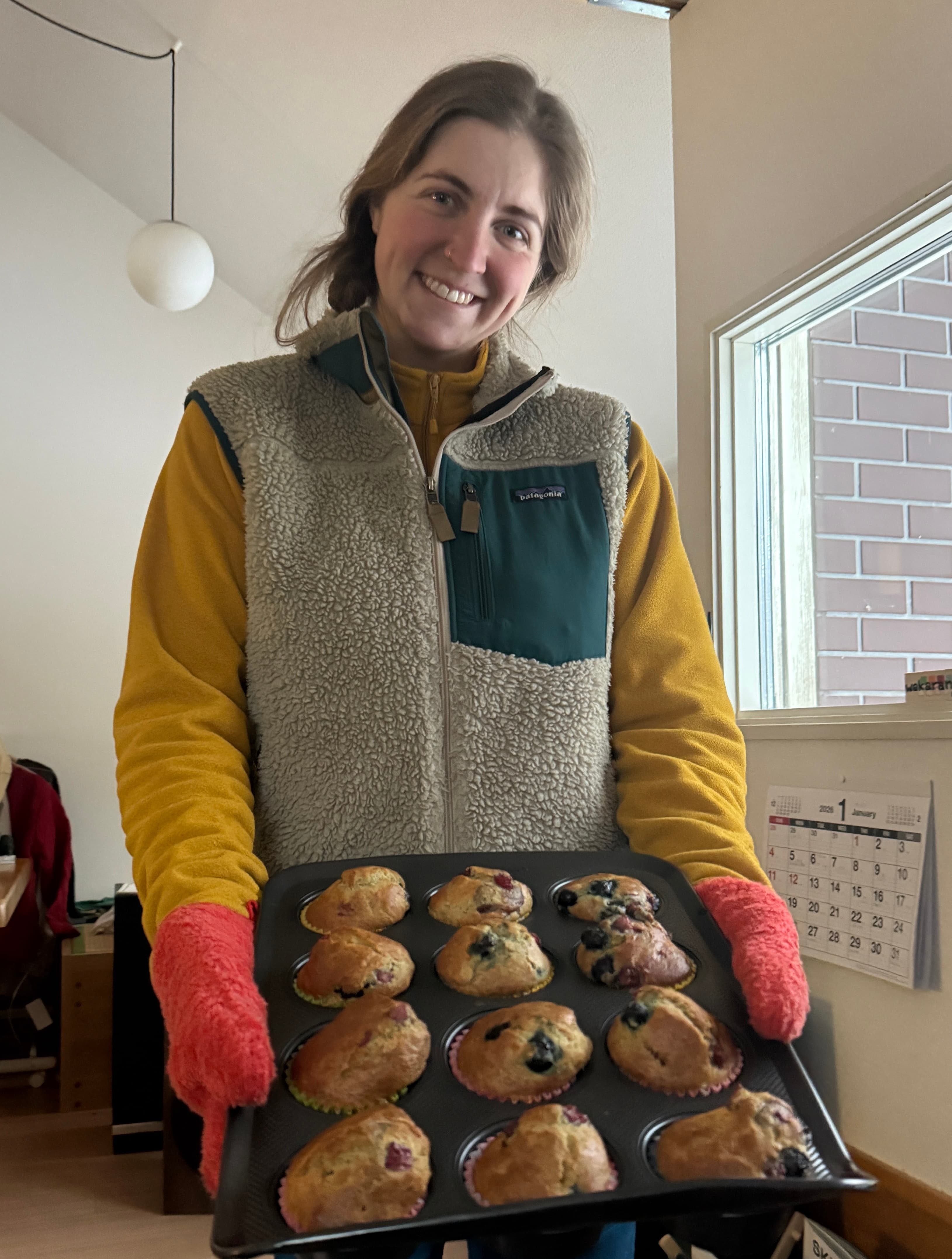 Denise holding a tray of freshly baked muffins at the lodge.