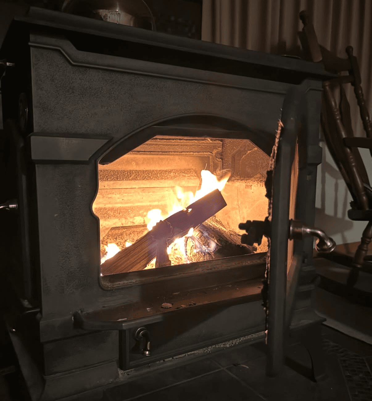 A wood stove with fire burning at Wakaranai Lodge.